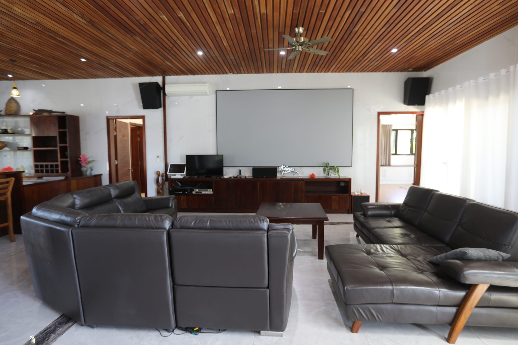 The home cinema with projector screen and lounges