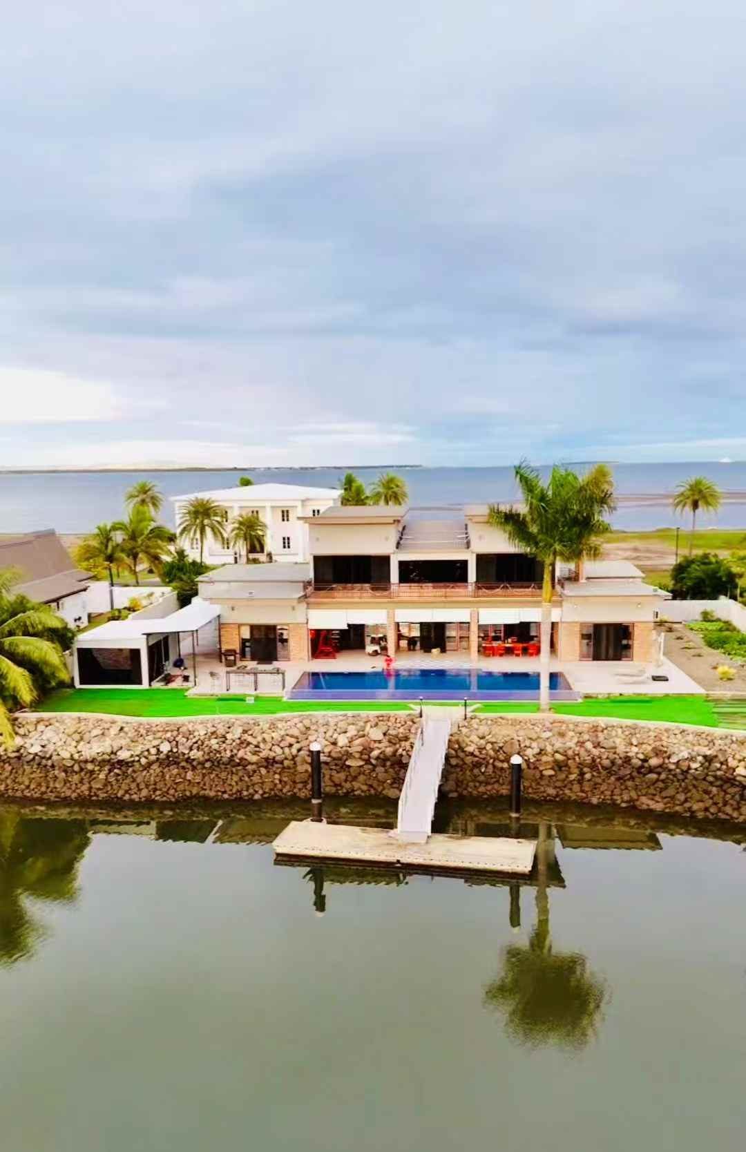 Villa 61's private dock reaching out into the lake, seen from the air