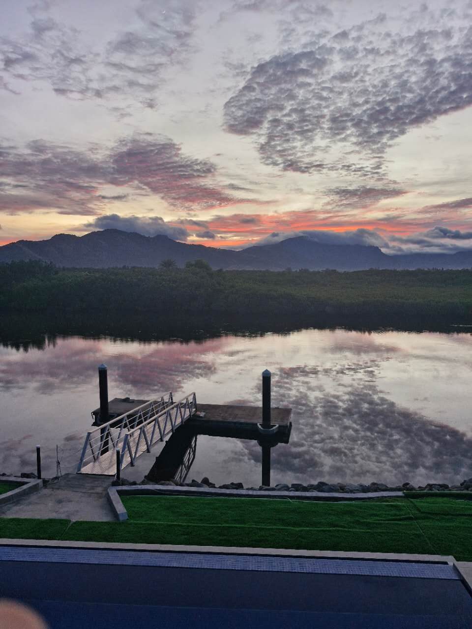 The dock at dusk with the mountains behind