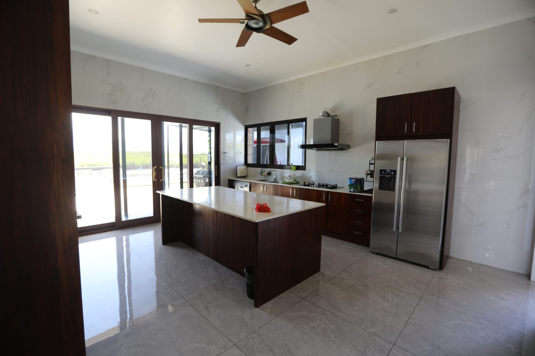 The kitchen with island bench and full appliances