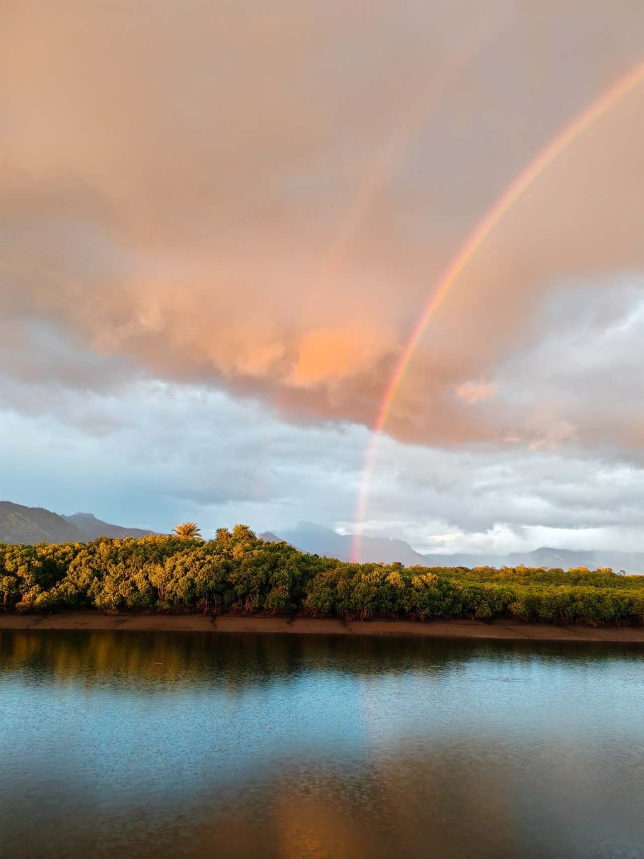 A rainbow over the lake beyond the villa