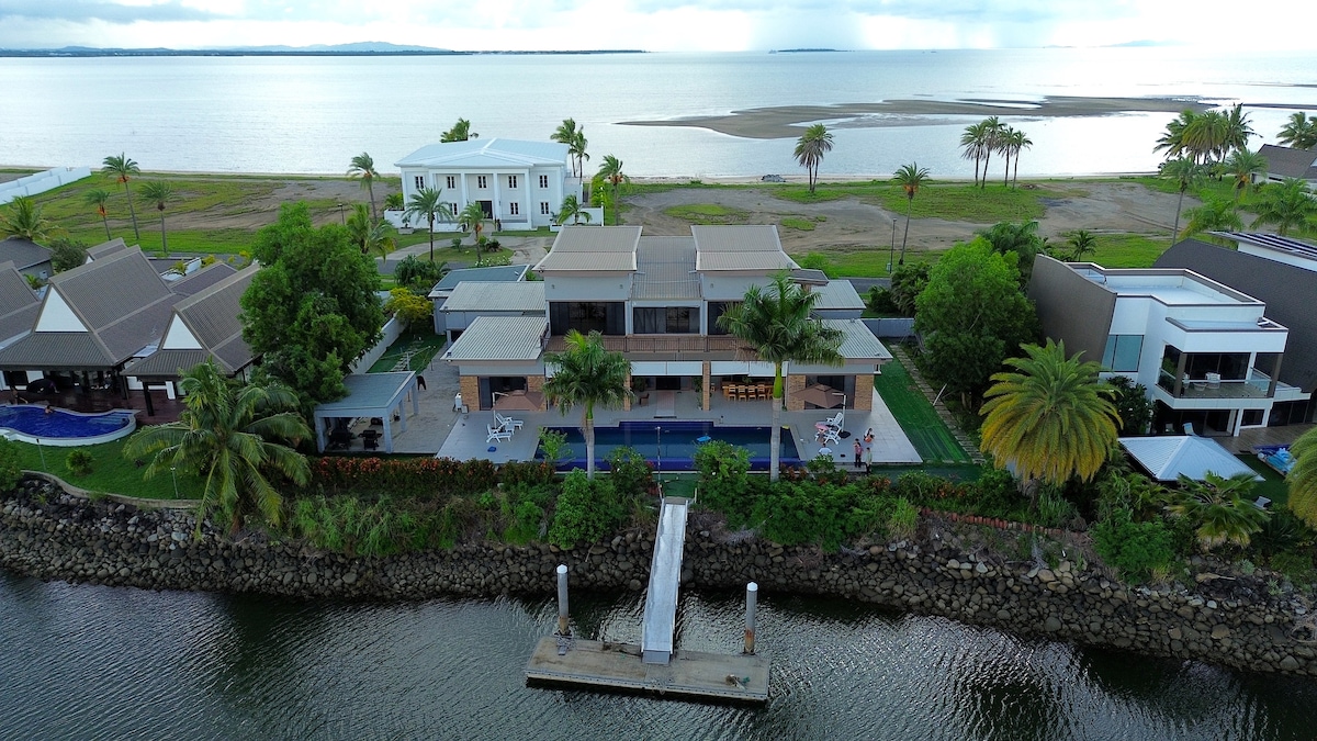 Aerial view showing Villa 61's island setting between lake and sea