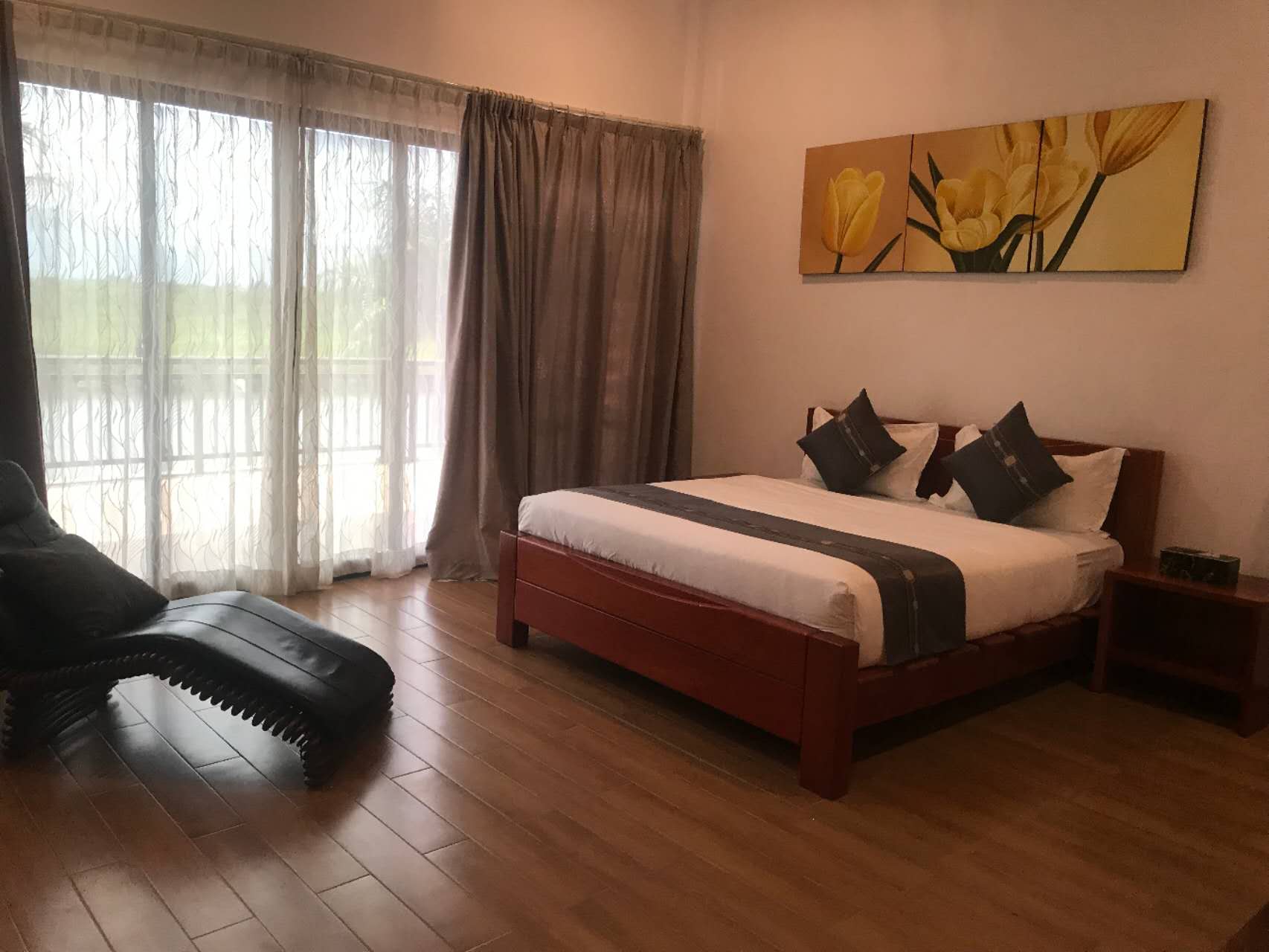 Upstairs master bedroom with king bed and doors onto the balcony