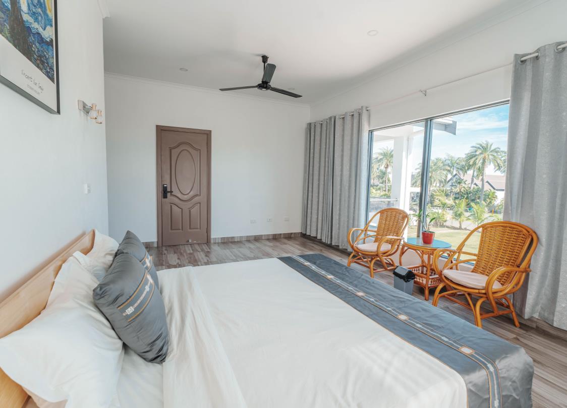 Bedroom 202 with king bed and sea-view window